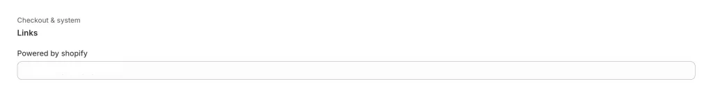 Find “Powered by Shopify” text box and replace with a single space